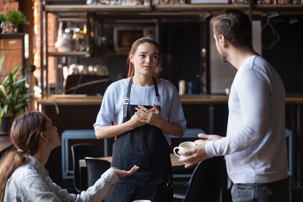 Waitress Talking With Upset Customers