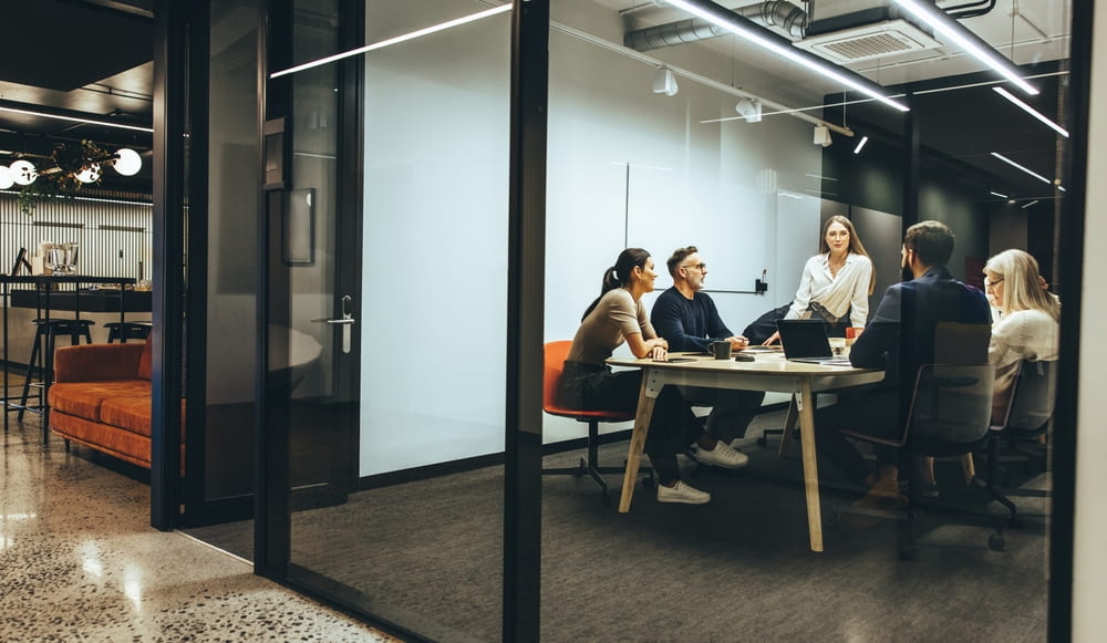 Coworkers Having A Meeting In A Glass Walled Room