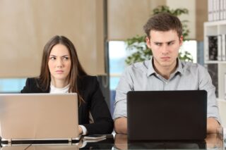 Woman And A Man Colleagues Giving An Angry Look To Each Other