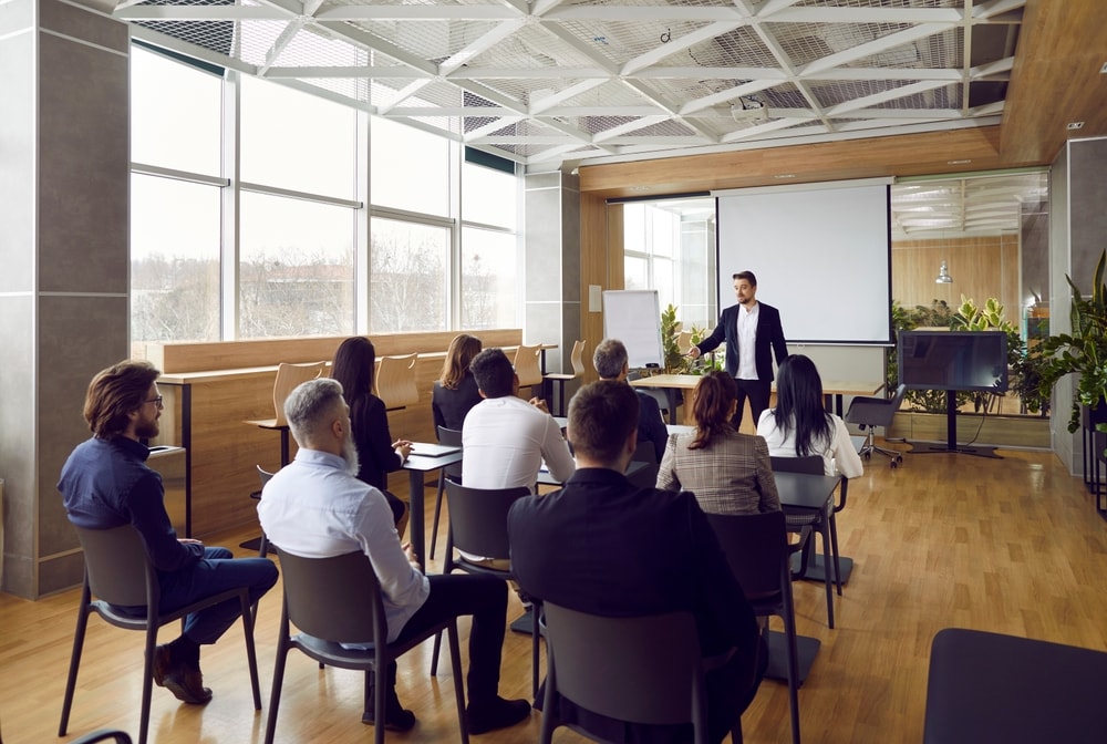 Male conflict coach presenting a seminar for conflict resolution.