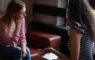 Young woman employee listening to constructive criticism