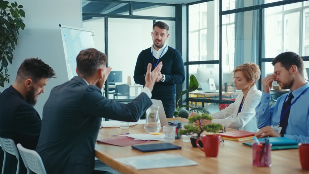 Boss executive telling bad news on corporate meeting presentation. Unhappy angry coworkers feel displeased complaining about company failure.