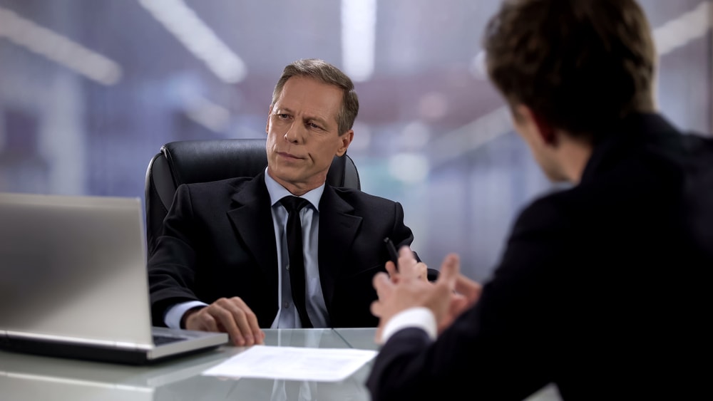 Male worker talking to arrogant boss ignoring him, opinion indifference at work